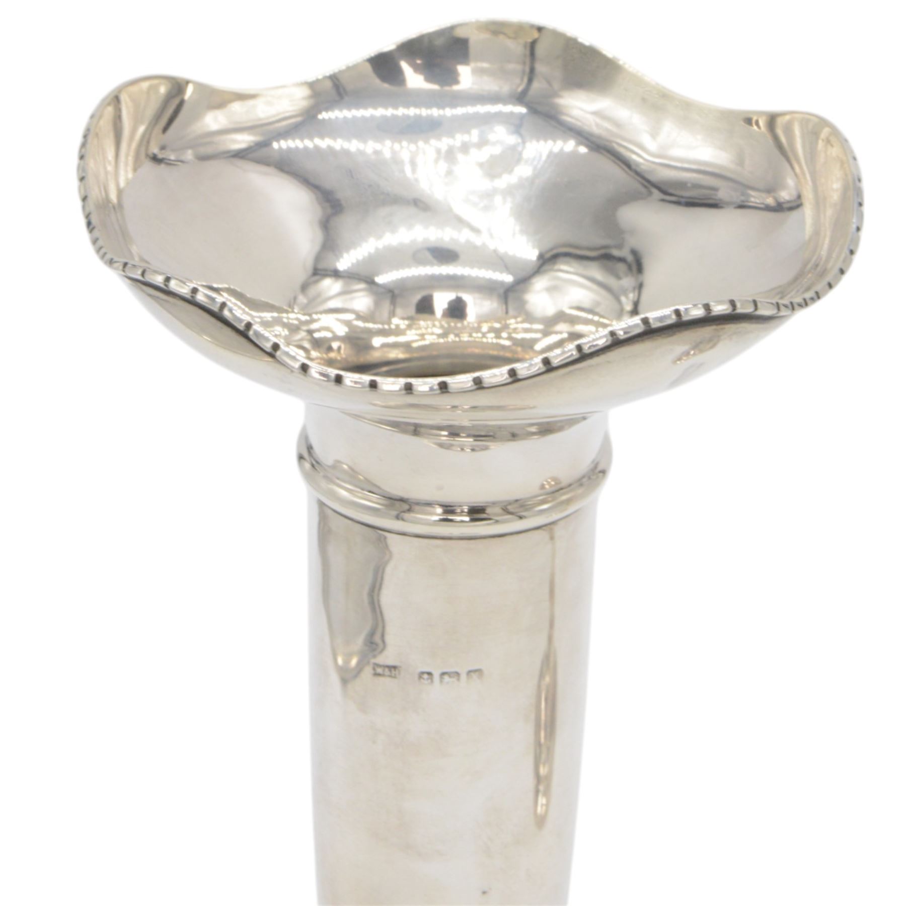 Two 1920s silver mounted trumpet vases, the first example of faceted form, hallmarked James Deakin & Sons, Sheffield 1921, the second example with fluted rim, hallmarked Walker & Hall, Birmingham 1922, tallest H25cm