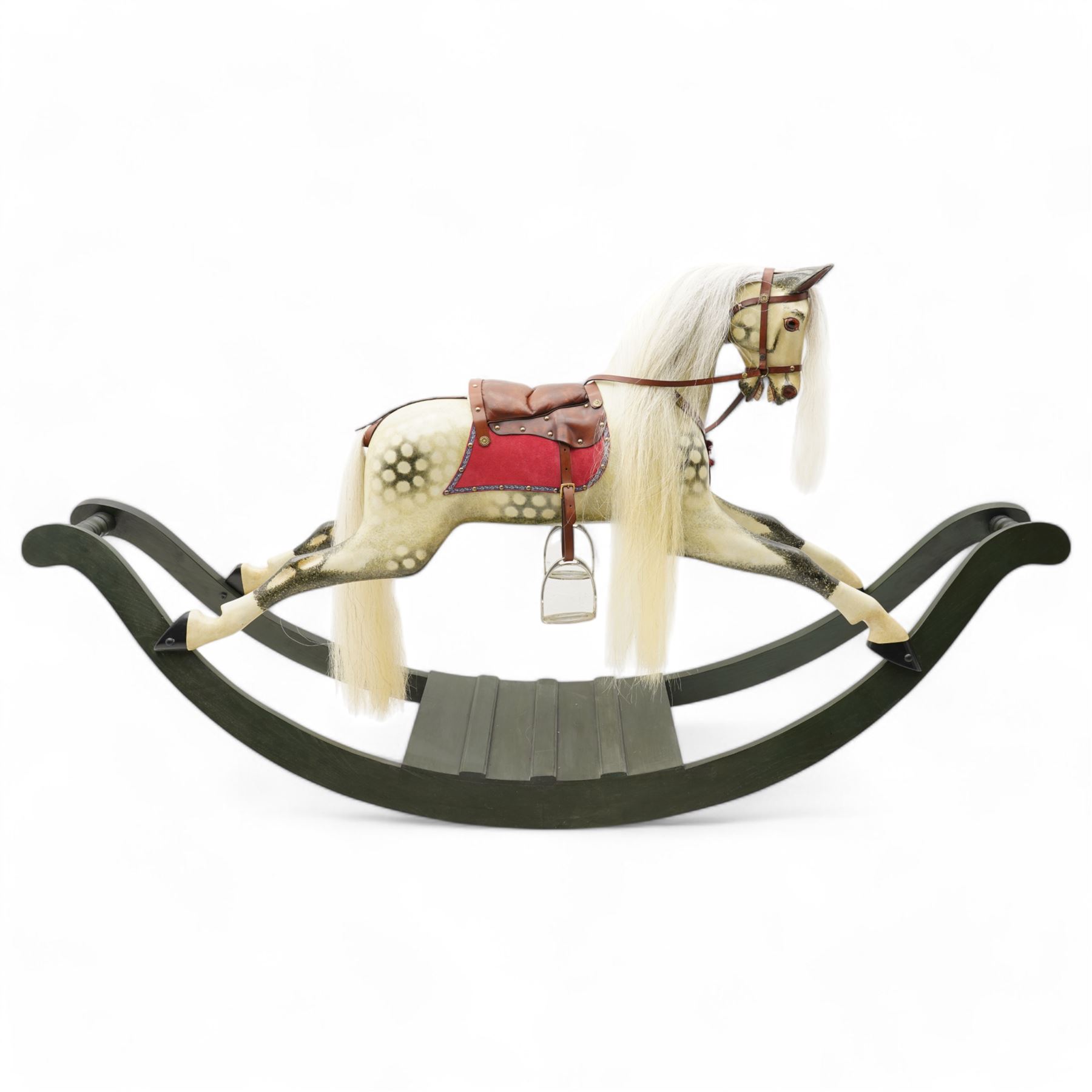 In the manner of F. H. Ayres - large carved wooden rocking horse, in dapple grey paint finish, decorated with glass eyes, leather reins, stirrup and saddle, on bowed rockers united by turned stretchers and boarded base 