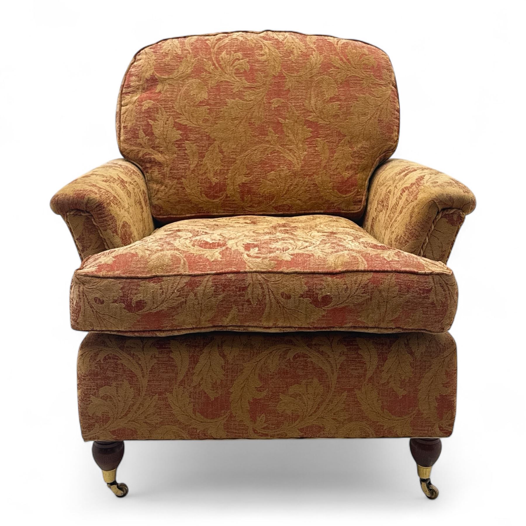 Duresta - Contemporary pair of upholstered armchairs, in red and gold damask style fabric, each with sprung seat and removable cushion back, rolled arms, on turned front supports with brass castors, square back legs 