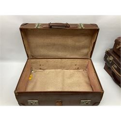 Four vintage suitcases of various sizes  