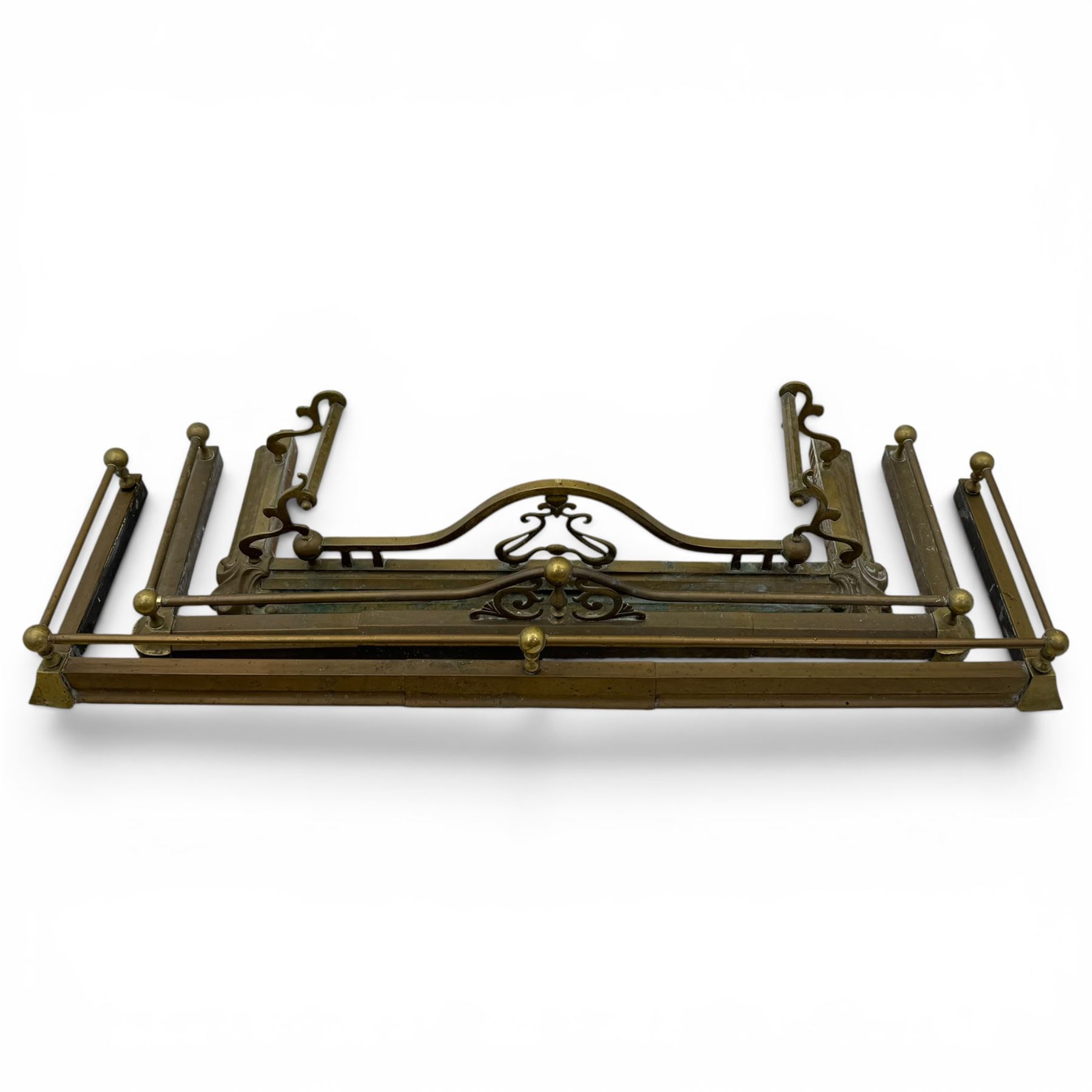 Three 20th century brass fenders, two with pierced Art & Crafts design rails, largest W156cm, D 45cm 