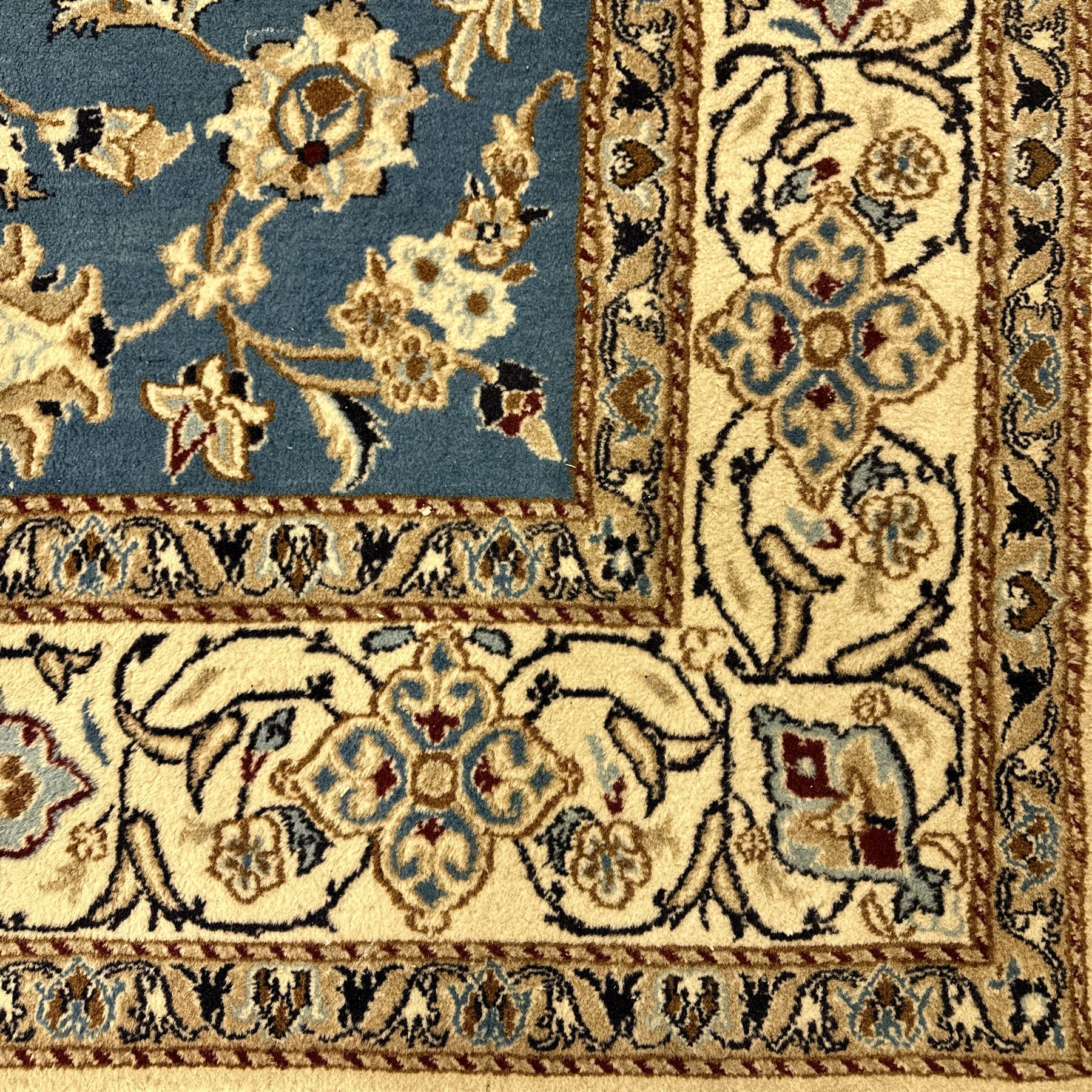 Central Persian Kashan rug, densely knotted, in a teal and cream ground, central medallion with circular rosette surrounded by a highly detailed field of radiating palmettes, vine arabesque patterns, rosettes, and  lotus blossoms, main border with alternating palmettes flanked by two narrower guard borders with a repeating floral meander design 
