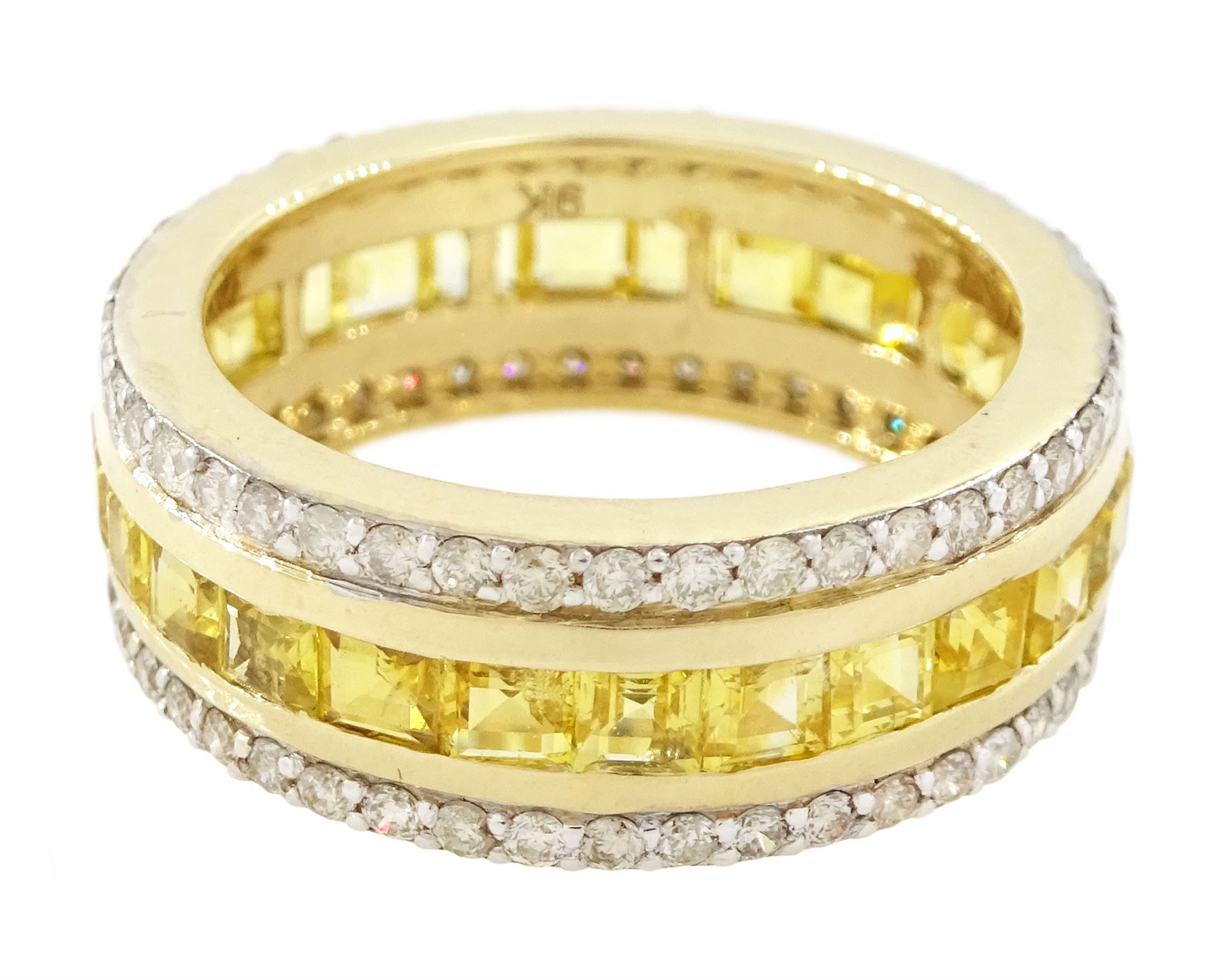 Gold yellow sapphire and diamond three row full eternity ring, channel set calibre cut sapphires, with a row of round brilliant cut diamonds set either side, stamped 9K, total sapphire weight approx 2.95 carat, total diamond weight 0.85 carat