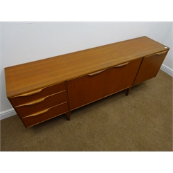 McIntosh teak sideboard, three graduating drawers, two cupboard doors enclosing a shaped shelf, single fall front unit, tapering supports, W202cm, H74cm, D48cm  