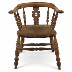 19th century ash and elm Windsor adapted armchair, continuous curved arm with turned spindle supports and shaped splat, saddle seat on turned legs united by crinoline stretcher