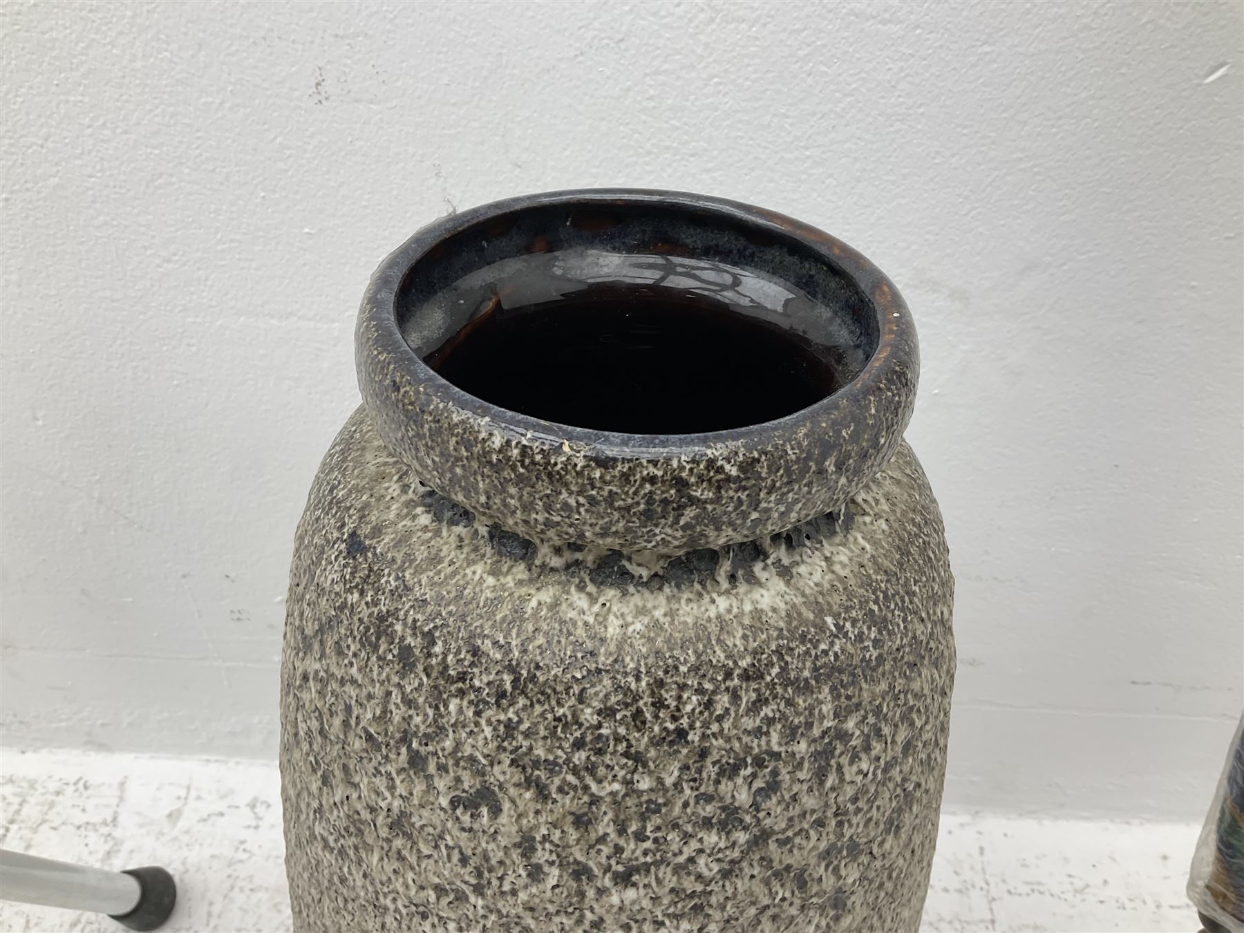 Two smooth polished ram horn handled Shepherd's crooks and a further similar example, together with various shooting sticks, walking sticks and canes, housed in a volcanic lava glaze West German style vase