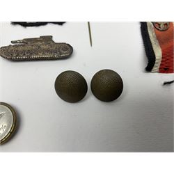 Collection of eleven German metal and cloth badges and uniform buttons including driver's badge, two 'SS' fabric skulls, private's shoulder tabs, Police cloth badge, tank destruction badge, medal bars and ribbon etc; most WW2 period