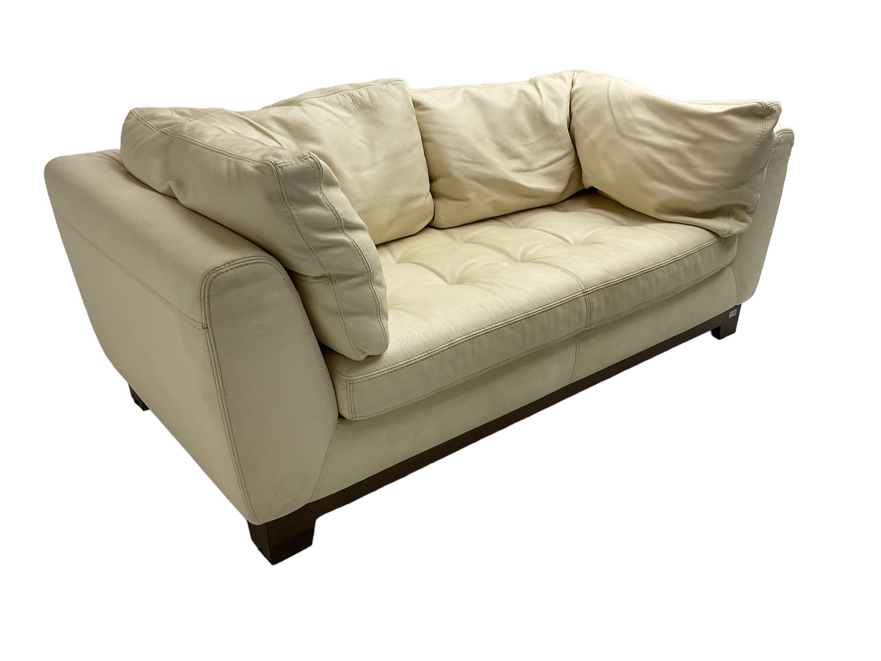 Roche-Bobois - two seat sofa, upholstered in ivory leather with buttoned seat cushions, raised on a stained beech base with bracket feet