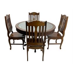 Pakistan carved hardwood brass inlaid circular dining table, and four rail back chairs with saddle seats