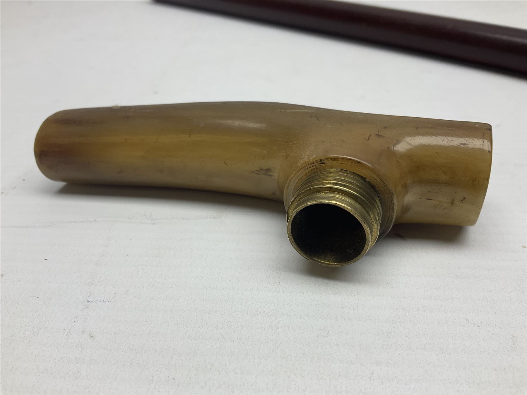 Victorian magician's cane, the mahogany walking stick twisting apart to reveal an internal mechanism, opening to tripod and black silk fold out magician's table, with horn handle and silver mount, hallmarked Birmingham 1891