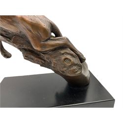 Bronze modelled as a cougar on a branch upon a rectangular wooden plinth, H24cm