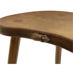 'Mouseman' oak three-legged stool, kidney shaped dished seat carved with mouse signature to edge, by Robert Thomas of Kilburn