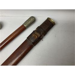 George V 1897 pattern Army Officer's sword by Henry Wilkinson Pall Mall London, the 82.5cm 'London Made' blade etched to both sides with Royal Crests and cyphers etc, pierced half-basket hilt with wire-bound fish skin grip and remains of leather knot strap; in leather covered field service scabbard L101cm overall; and two 14th Prince of Wales Own swagger sticks (3)