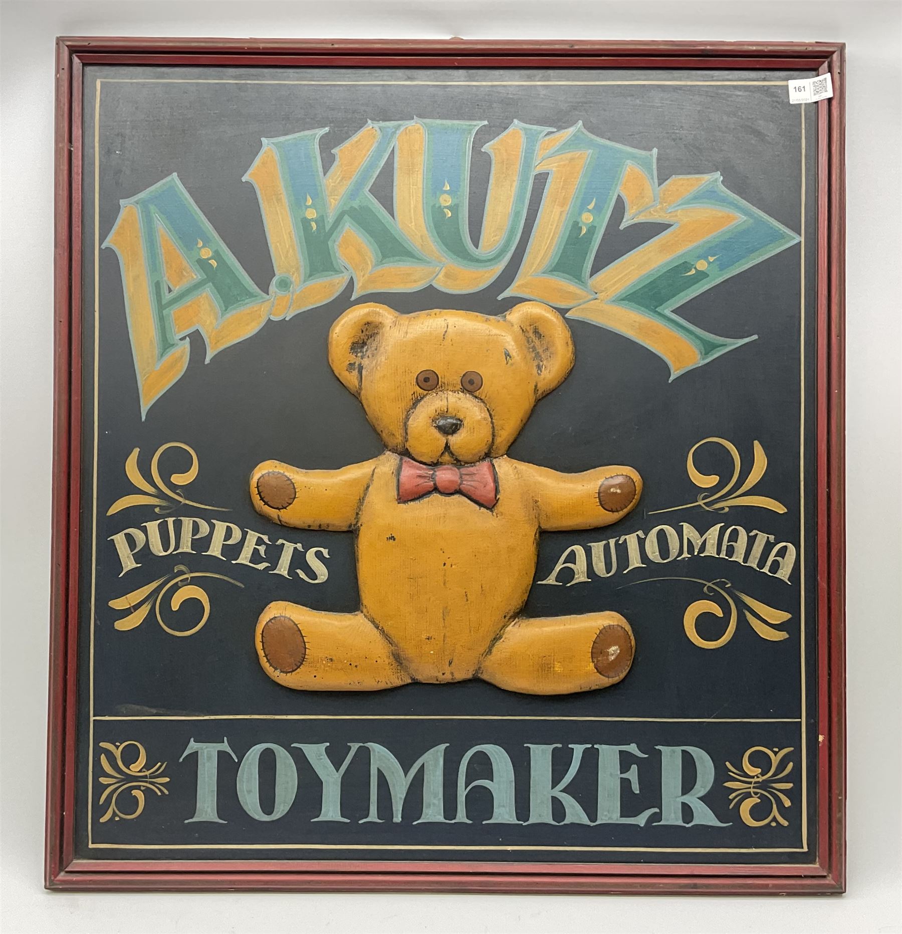 A Kutz Toymaker sign with central low relief decoration of a teddy bear, H76cm L71cm.