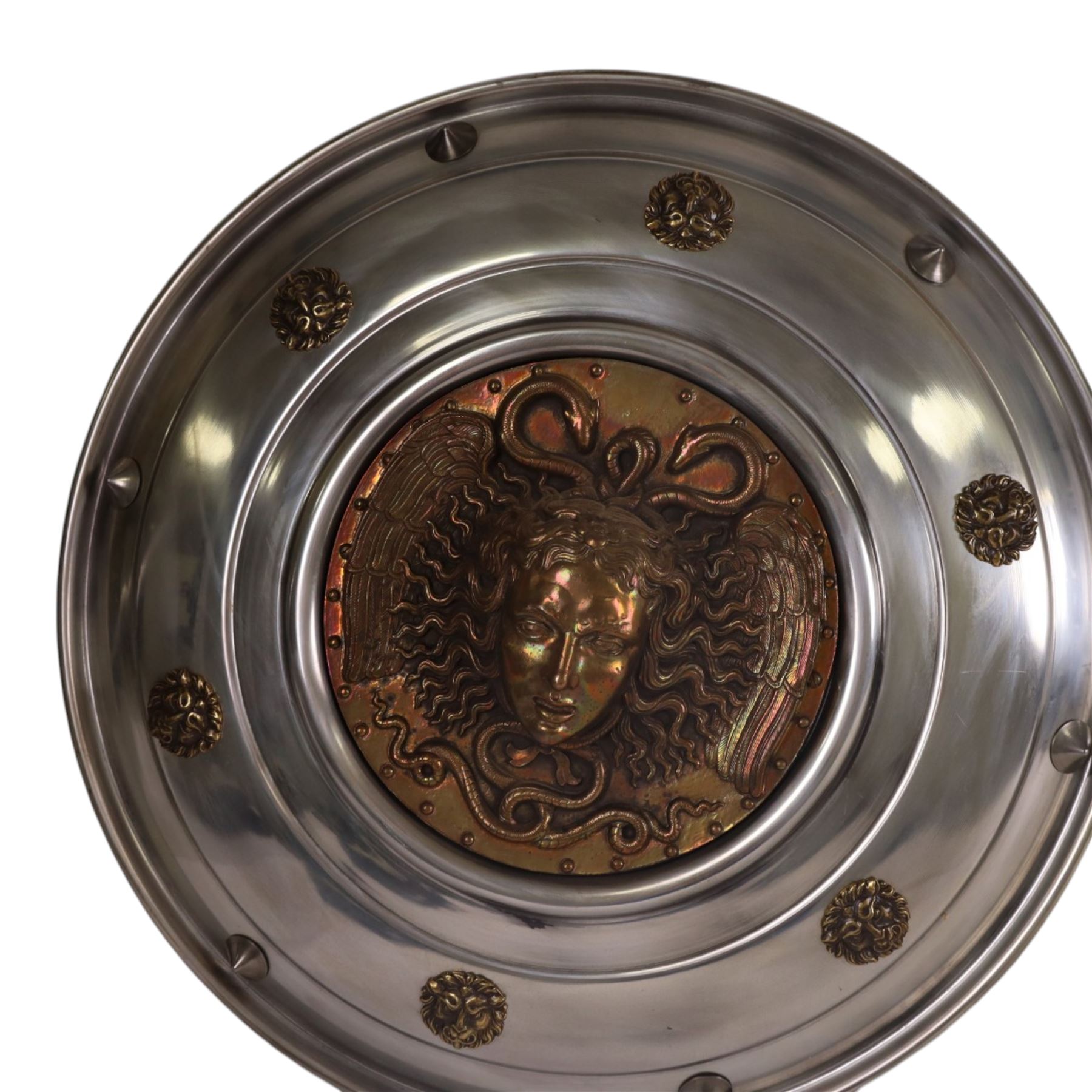 Three wall hanging shields the central panel decorated in relief with Medusa, D56cm 
