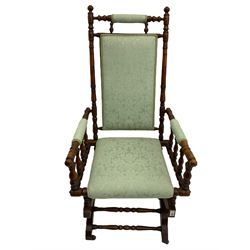 Early 20th century walnut framed American rocking chair, upholstered seat, back and arms
