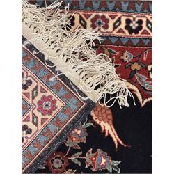 Persian-style wool rug, cream field with floral and geometric motifs, wide floral border (74cm x 142cm); Persian wool rug, beige field with dense floral patterns, narrow floral border (70cm x 144cm); Tribal wool rug, red and navy with diamond motifs (96cm x 60cm); Persian pictorial wool rug, black field with vase, birds, and floral border (70cm x 73cm)