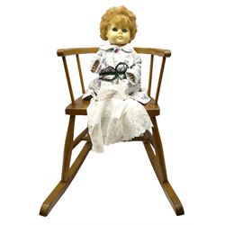 1950's Vinyl doll with applied hair, sleeping eyes and hard plastic jointed body H55cm; in beech and elm seated stick-back rocking chair (2)