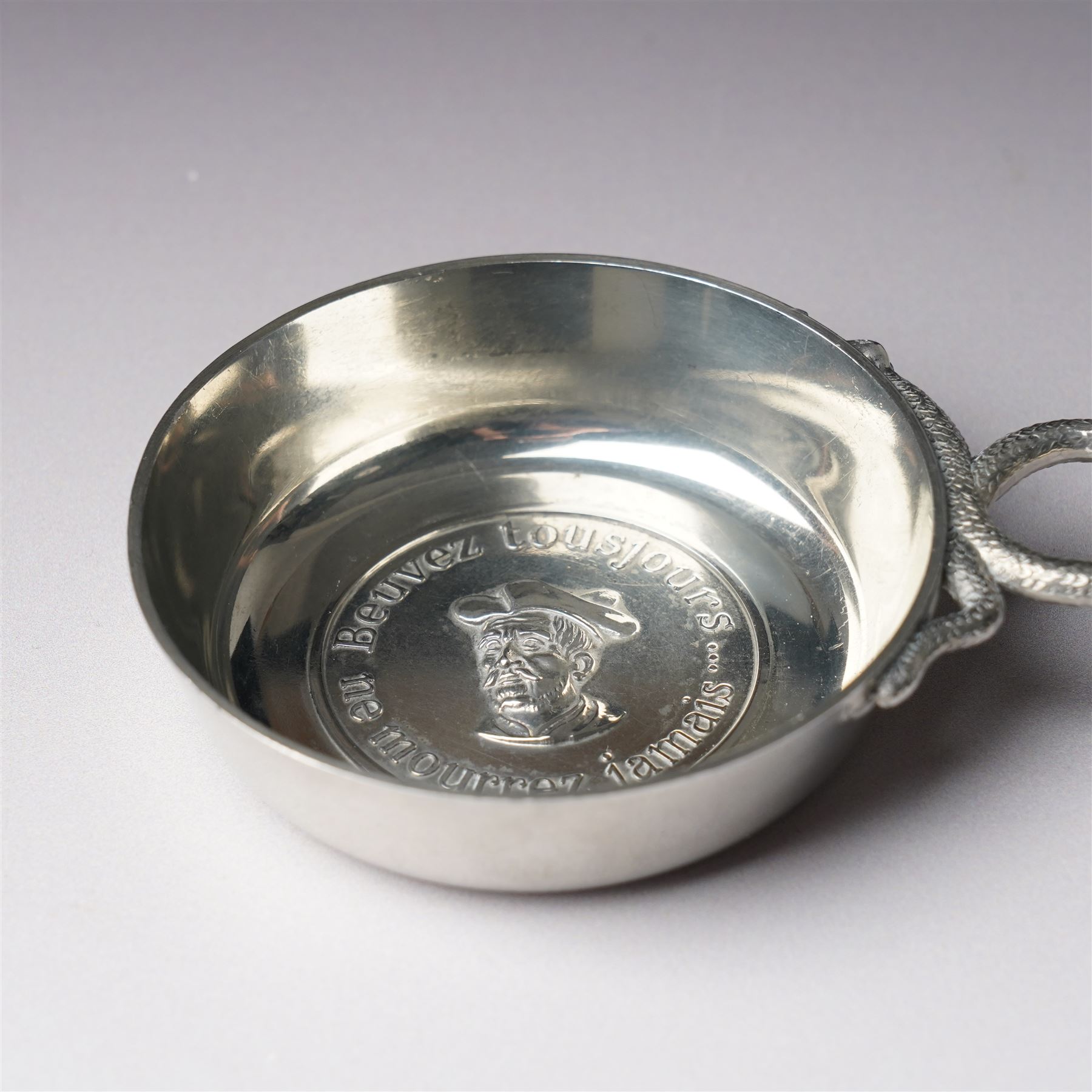 French silver tasse de vin with Minerva's head and makers mark J.P. with an anchor, the rim engraved C Mouly, Spanish tasse de vin inset with a silver coin and two other tasse de vin (4)