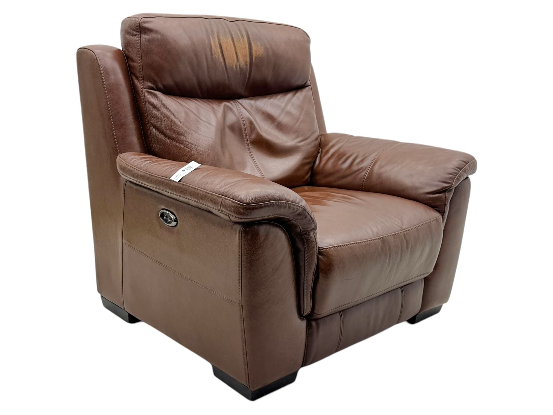 DFS - 'Liaison' reclining armchair upholstered in brown leather, upholstered in tan leather with stitched panel backrest and generously cushioned seat and arms, operated by wired remote, raised on block feet