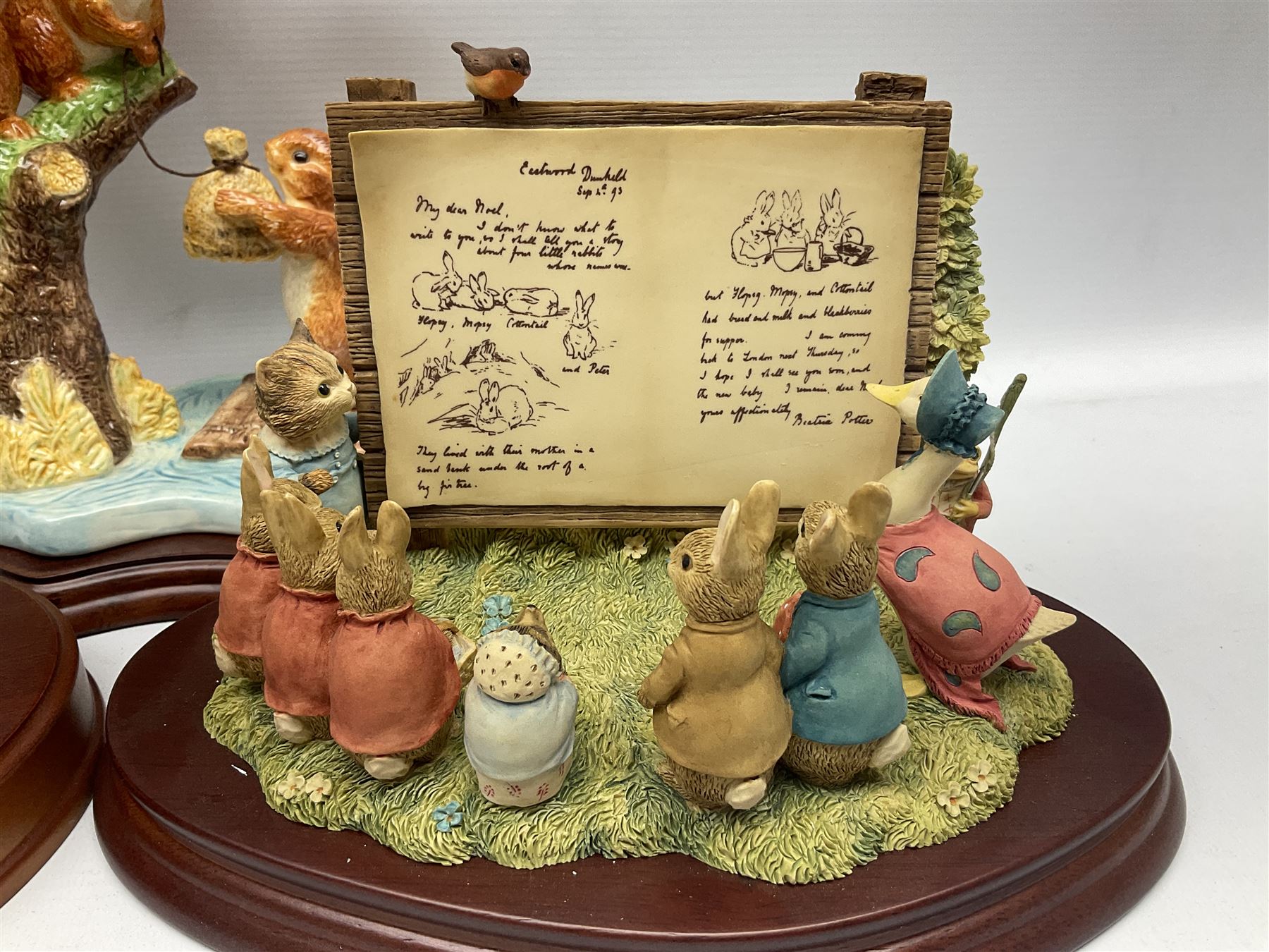 Four Border Fine Arts Beatrix Potter figures, comprising Tableau created to commemorate the Millenium together with a Border Fine Arts Limited Edition no 669814, The Tale of Peter Rabbit Tablet A1306, Four Little Rabbits A2442 and Sailing Home A2443