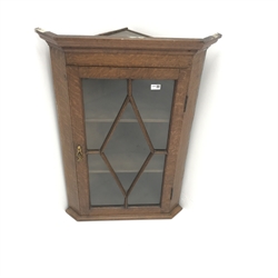  Georgian oak hanging corner cabinet, single glazed door enclosing two shelves, W69cm, H99cm, D43cm  