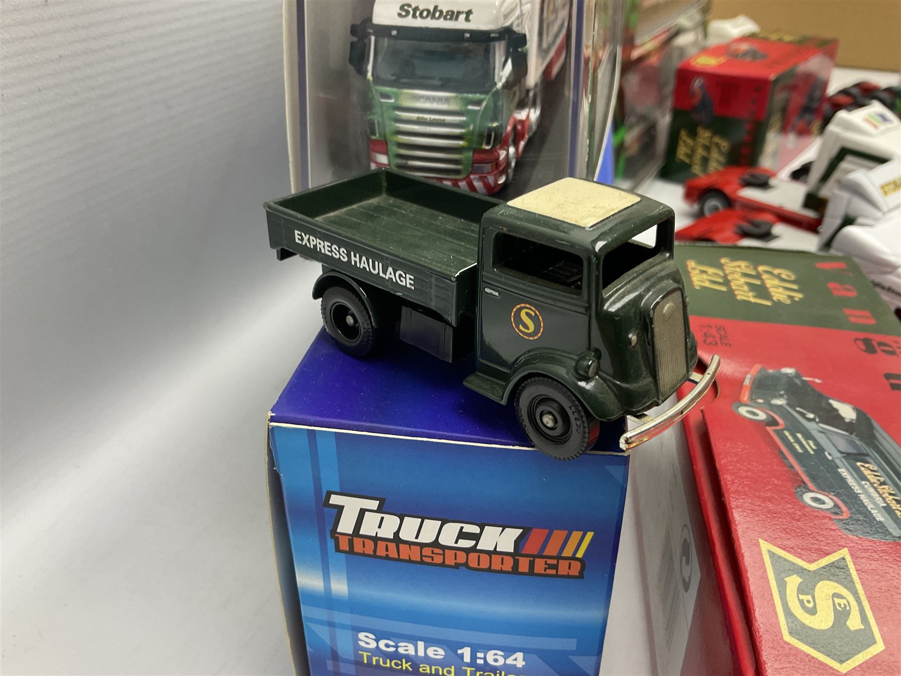 Eddie Stobart - three Oxford Die-Cast Super Rugby League lorries in perspex display cases including the two Hull Clubs; two Lledo Vanguard vans; two Days Gone vans; and Saico Truck & Trailer; all boxed; together with fourteen unboxed Corgi and other tractor/cab units etc (23)