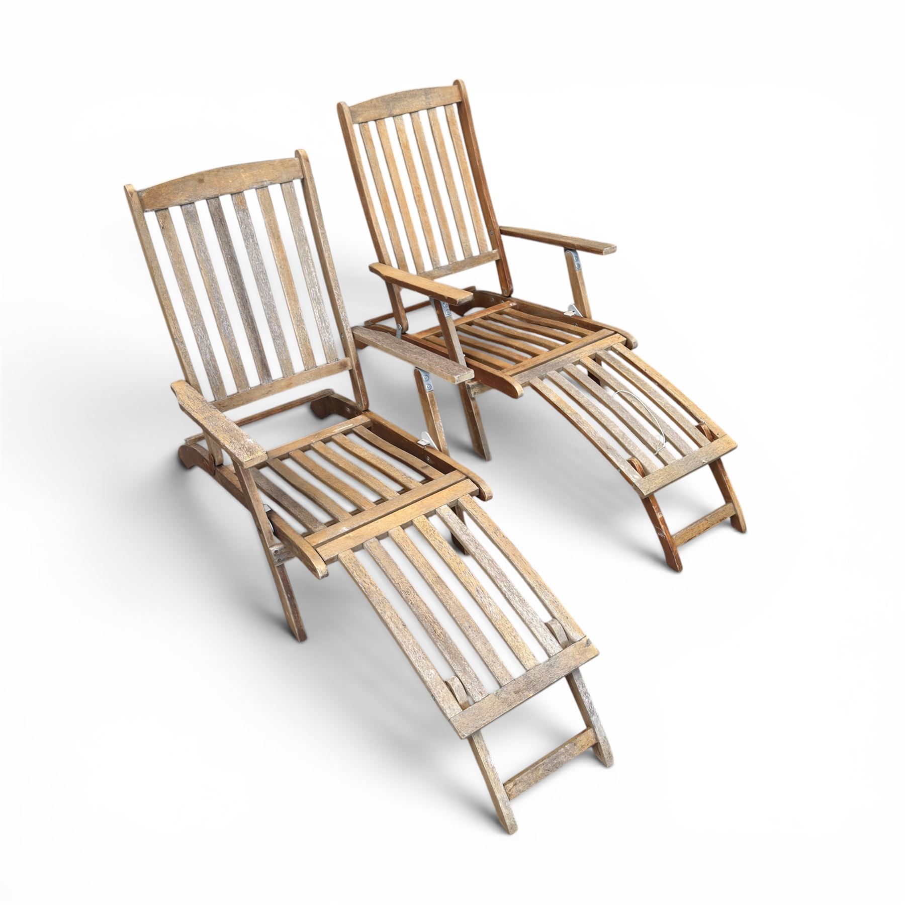 Pair of teak folding steamer chairs, with slatted backs, seats and extending footrests, adjustable recline.