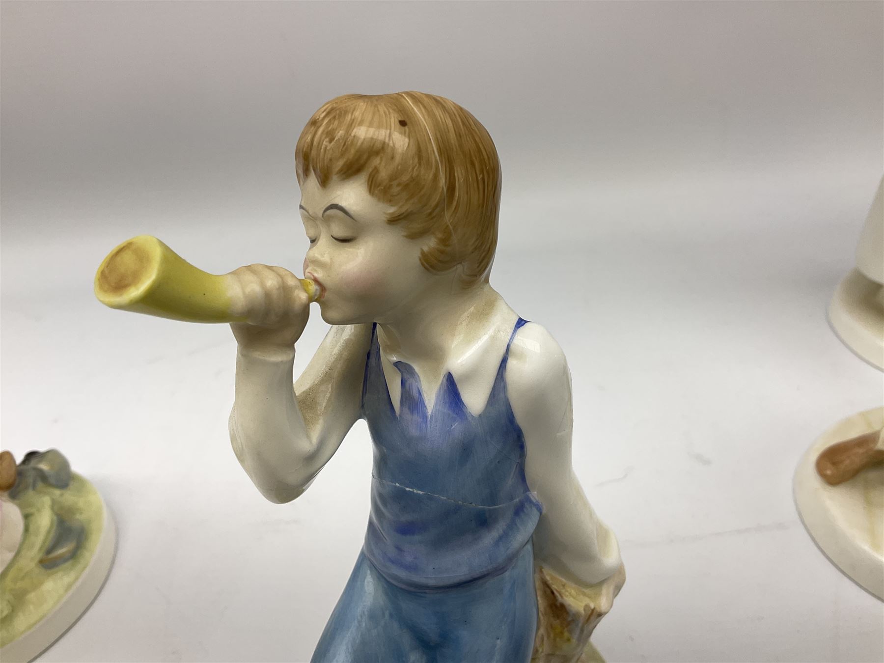 Seven Royal Doulton figures from the Nursery Rhymes Collection comprising, Tom Tom, the piper's son HN3032, Little Jack Horner HN3034, Wee Willie Winkie HN3031, Polly, put the kettle on HN3021, Little Bo-peep HN3030, Little Boy Blue HN3035, Little Miss Muffet HN2727, together with two Royal Doulton Mary had a little lamb figures HN2048 and COPR1948, all with printed marks beneath  