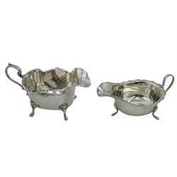 Silver milk jug, shell and scroll border, on four scroll feet by Walker & Hall, Birmingham 1929, and one other by Viner's Ltd, Sheffield 1932, approx 9.5oz