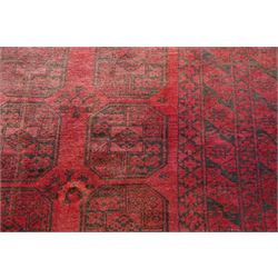 Afghan crimson ground Bokhara rug, the field with three rows of repeating Gul motifs, within six concentric guard bands decorated with repeating geometric patterns