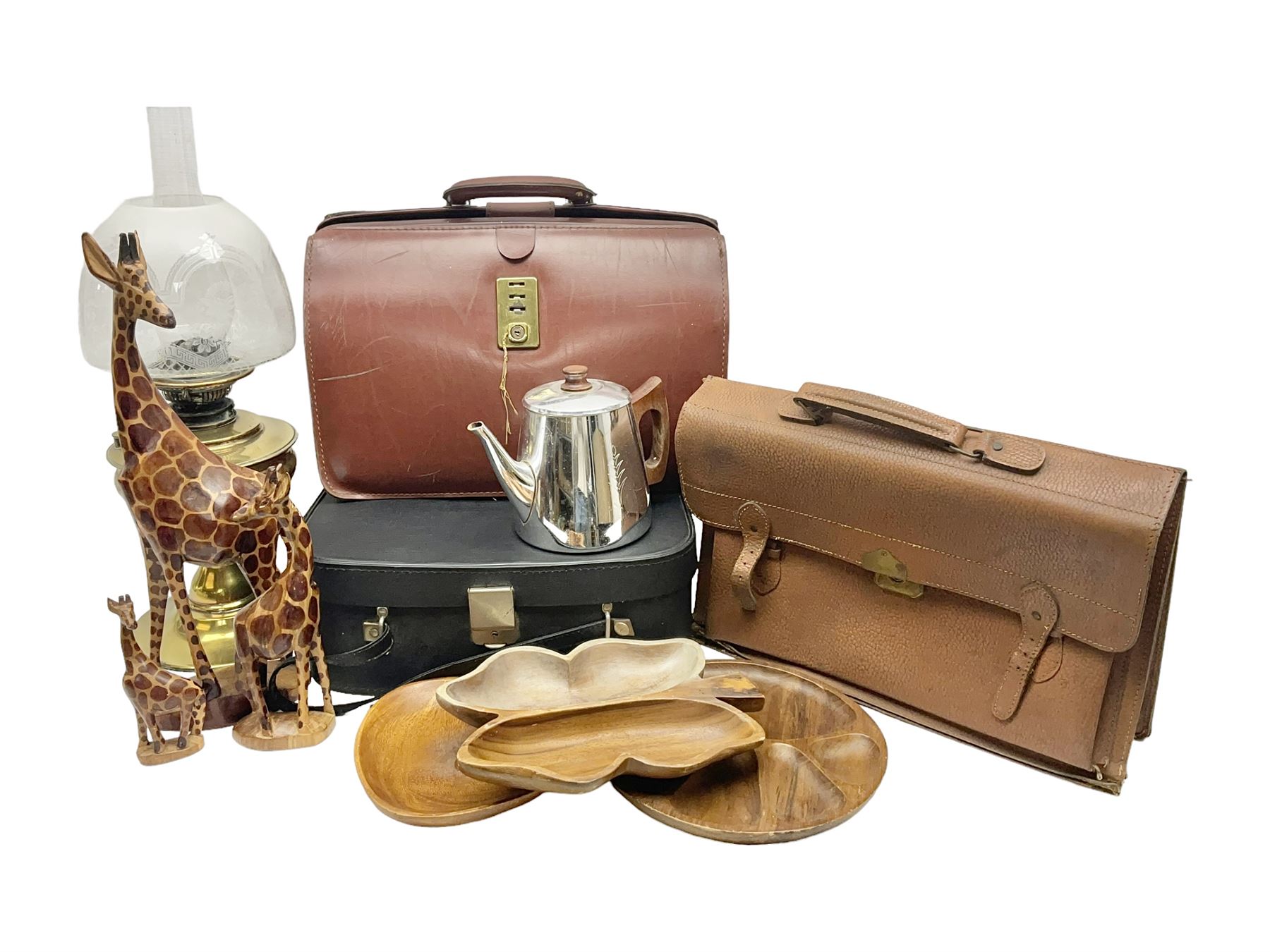 Brass oil lamp, with etched floral glass shade, leather Gladstone style doctors bag, leather satchel and vintage vanity case, three graduating wooden giraffes and other wood and metal ware, lamp H54cm