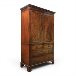 George III mahogany linen press, projecting dentil cornice, moulded doors enclosing a shel...
