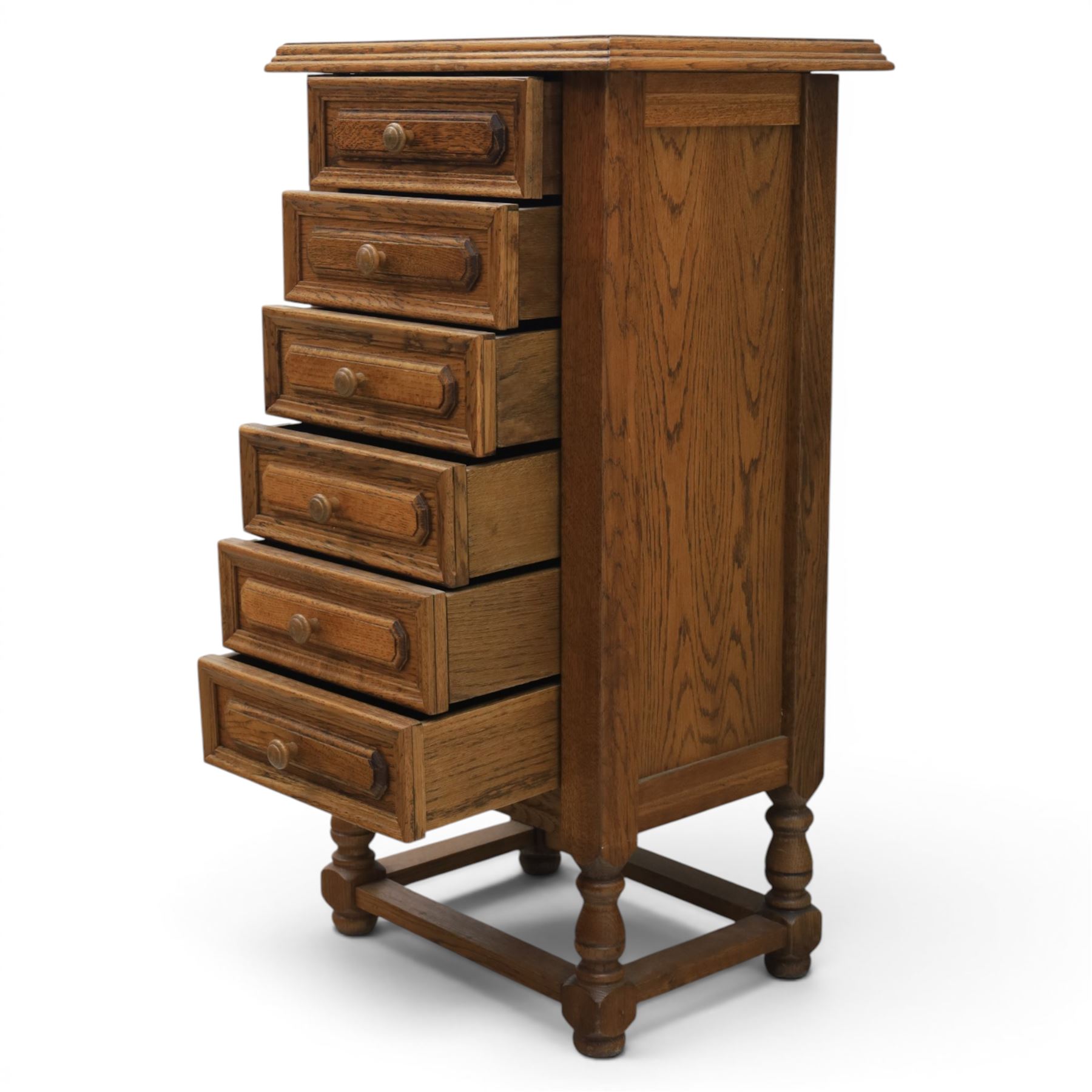 Early 20th century oak pedestal chest, with six drawers with moulded edges, raised on turned supports united by a stretcher 