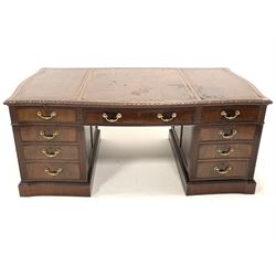 Quality London Georgian design serpentine mahogany twin pedestal partners desk, the top inset with tooled leather writing surfaces over six drawers, each pedestal fitted with drawer and one partitioned deep drawer, opposite panelled cupboard enclosing seven plan drawers, with panelled sides, fluted and floral carved decoration, brass drop handles, raised on plinth base, bearing ivorine retailors plaque reading 'JETLEY, LONDON' all drawers oak lined and fitted with HOBBS & CO locks, 190cm x 114cm, H79cm