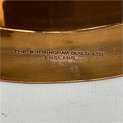 Birmingham Guild of Handicraft copper bowl, of circular form, the broad rim stamped with circles and fruiting sprigs, raised upon three cast brass feet, with impressed mark beneath The Birmingham Guild Ltd England, D30.5cm