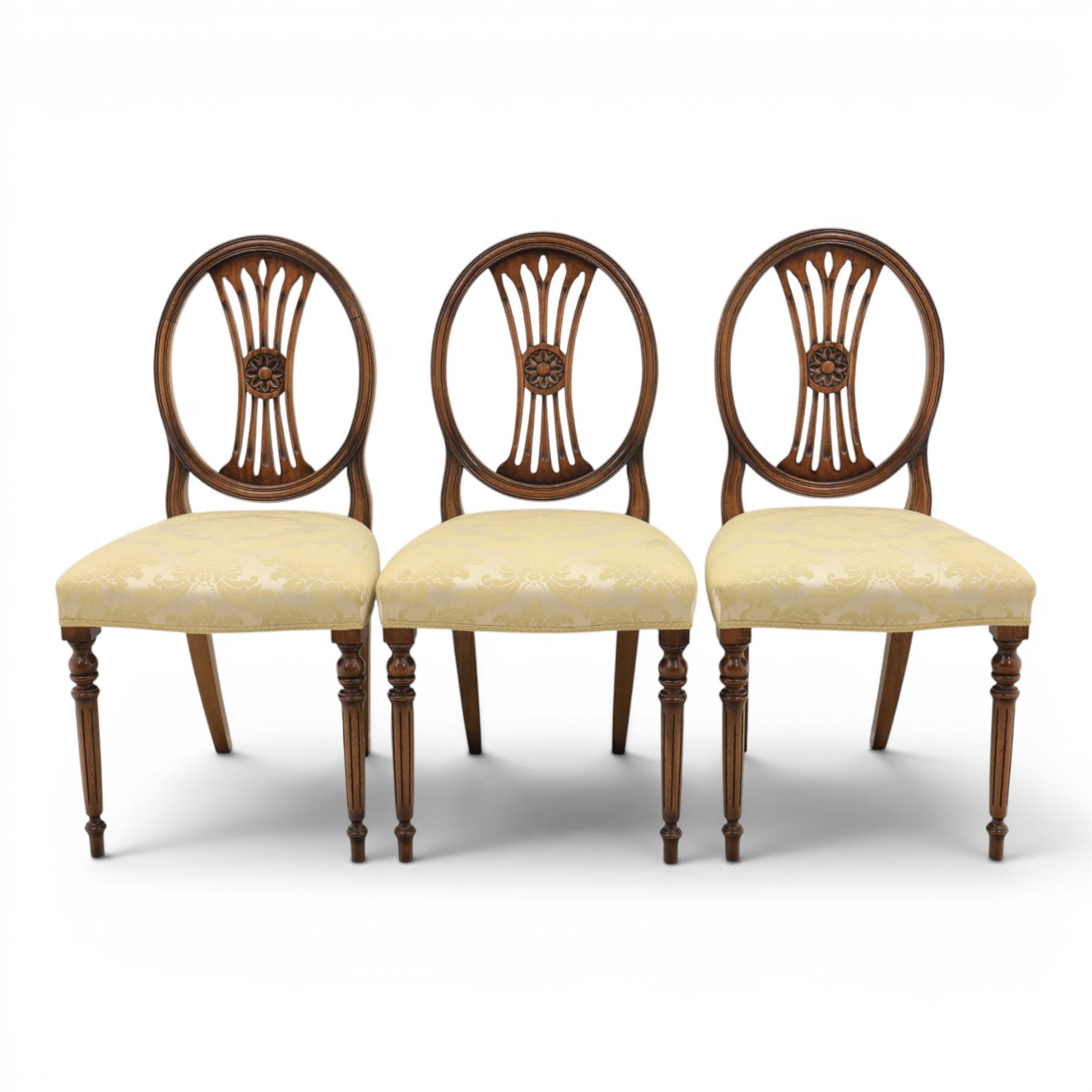 Bevan Funnell Reprodux - Regency design set of ten mahogany dining chairs, oval backs with central splat with rose motif, serpentine seat upholstered in damask fabric, raised on turned supports