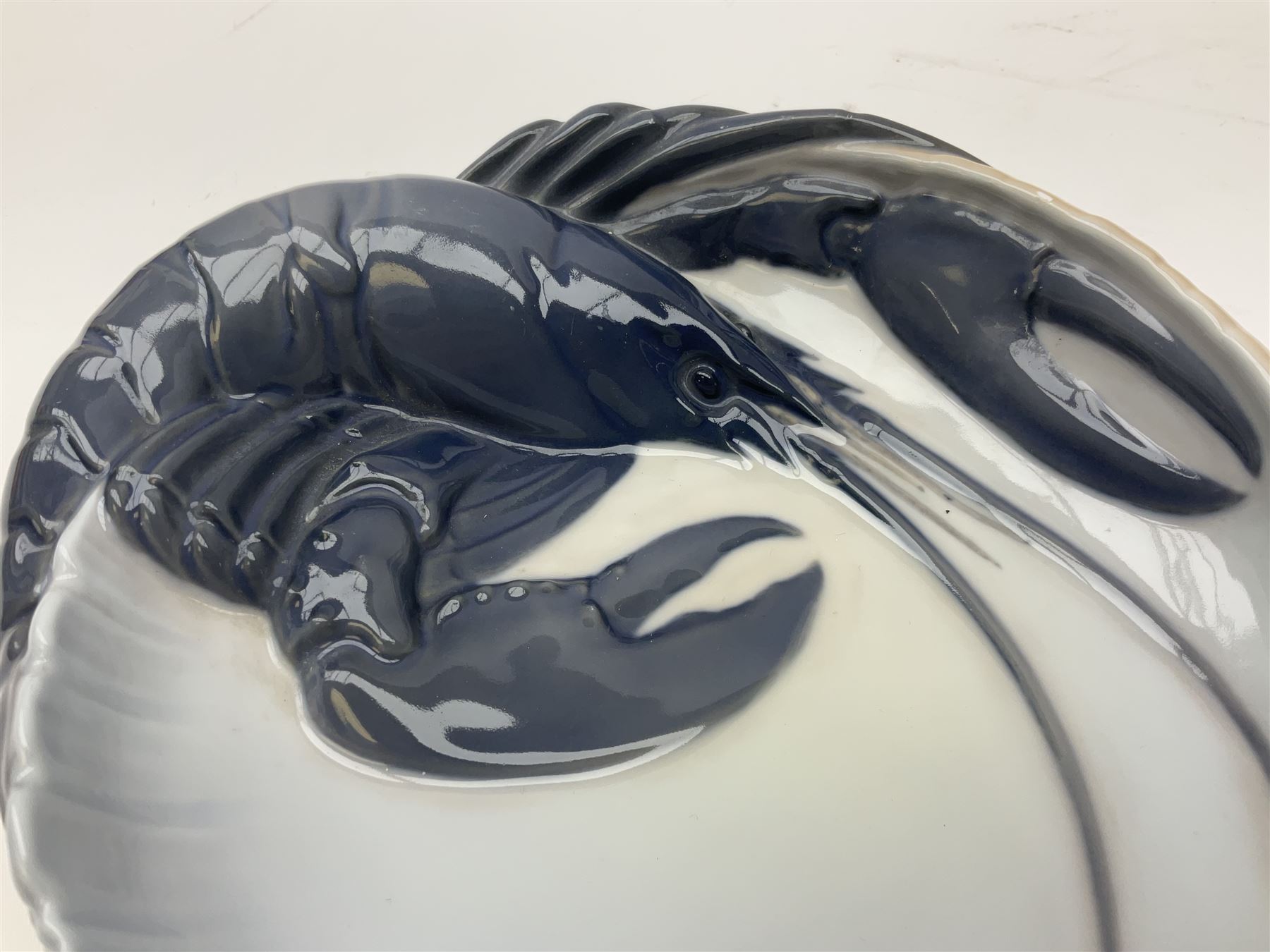 Pair of Royal Copenhagen bowls modelled as baskets and mounted with lobsters, model no 3498 and 3277, with painted and printed marks beneath, largest D19cm