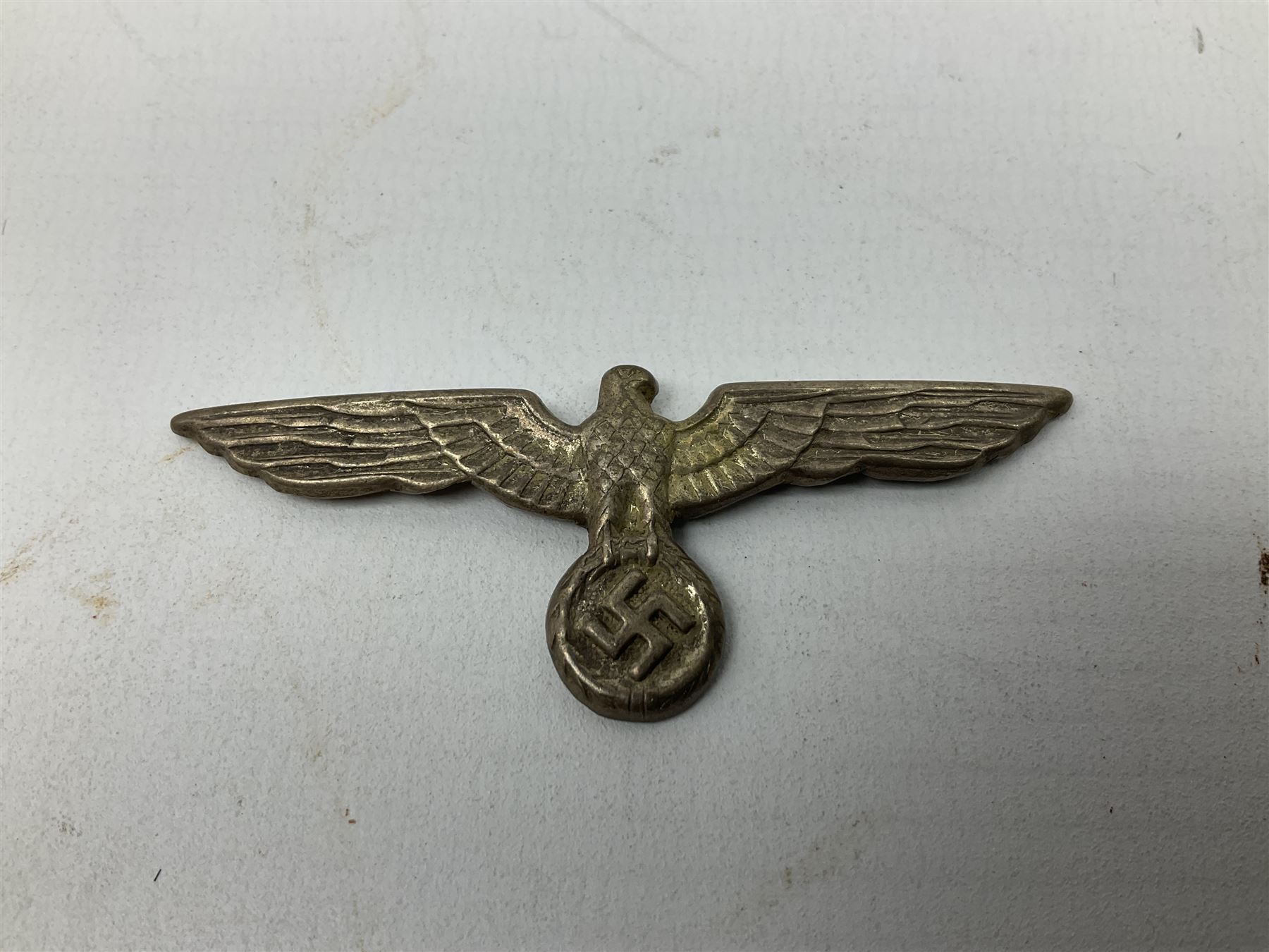 Five WW2 German peaked cap badges, four with double-pinned backs