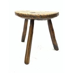 18th century elm three legged stool,  D-shaped top with three splayed supports, visible wedged joints 