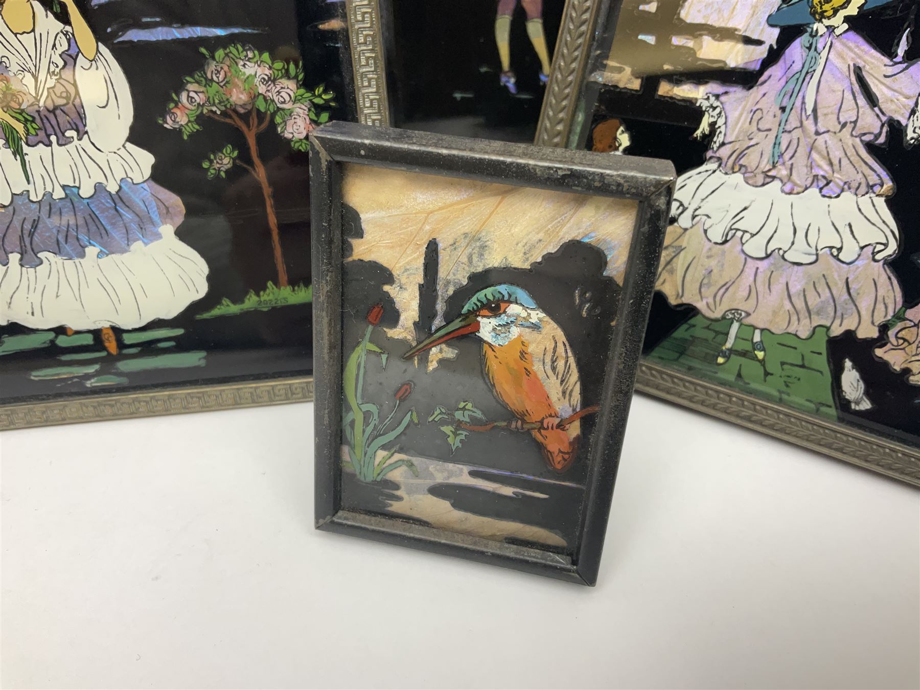 Seven 1930's butterfly wing pictures, mainly of ladies in period dress, one signed Dorothy Buckley, largest H18cm