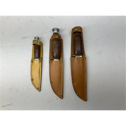Graduated set of three Bowie knives by J. Nowill & Sons Sheffield England Est. AD1700, each with steel blade, brass cross-piece, stacked leather type grip and alloy pommel; largest blade 13cm and smallest 7.5cm; each in leather sheath (3)