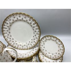 Modern Spode coffee and dinner wares for six place settings, decorated in the Fleur De Lys Gold pattern, comprising dinner plates, dishes, side plates, one handled fan shaped serving dish, coffee pot, coffee cans, saucers, open sucrier and cream jug, with red and black printed marks beneath 