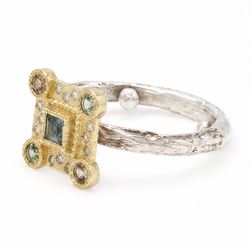18ct gold and silver blue topaz, sapphire diamond dress ring, square cut blue topaz, surrounded by round brilliant cut diamonds, the corners set with green and orange / brown sapphires,stamped 18K 925