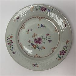 Three 18th century Chinese Famille Rose plates, the first example enamelled with blossoming peonies, rockwork and fence, the other two examples of similar design, decorated with blossoming peonies and sprigs within shaped inner borders, each approximately D23cm