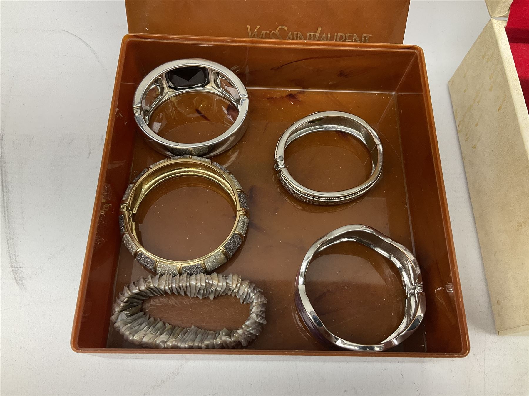 Collection of costume jewellery including enamel and marcasite flower brooch, two V Villani Italy bangles, clip on earrings, brooches, bangles, beaded necklaces and a Skagen wristwatch