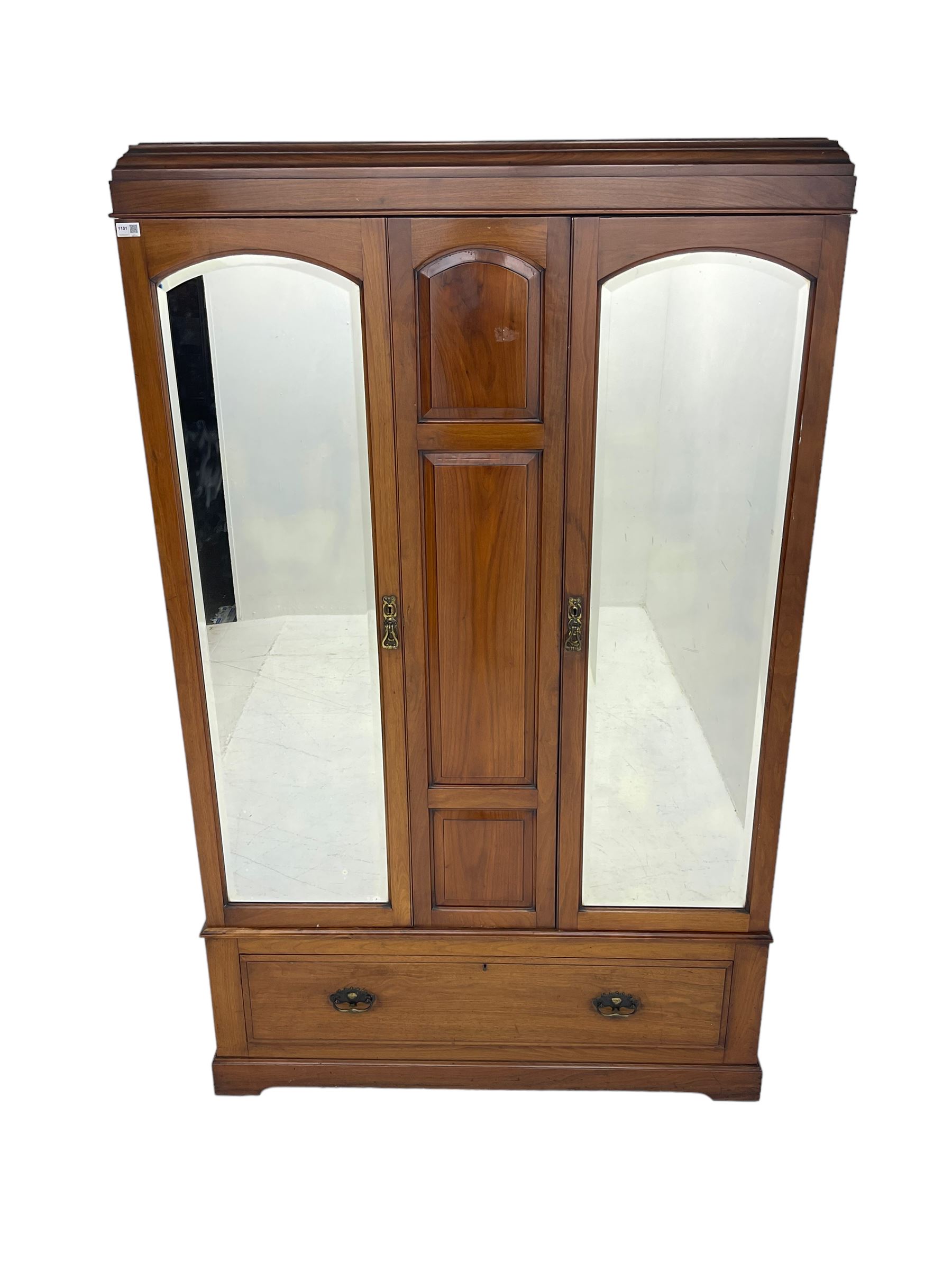 Edwardian walnut double wardrobe, fitted with two bevelled mirror panelled doors, single drawer to base