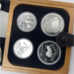 Six Queen Elizabeth II The Royal Canadian Mint silver proof four coin sets, to commemorate the 1976 Montreal Olympic Games, each set containing two five dollar coins and two ten dollar coin with Queen's head obverse and designs to the reverse relating to the Olympic Games, all in the original display cases and outer card boxes with certificates