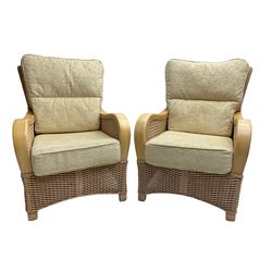 Contemporary rattan conservatory suite - two seat sofa with wicker frame and loose cushions upholstered in textured champagne fabric (W125cm H98cm); pair of matching armchairs (W72cm H98cm); rectangular glass-topped coffee table with rattan frame and undertier (W85cm D60cm H47cm); and matching square side table (W53cm H55cm)