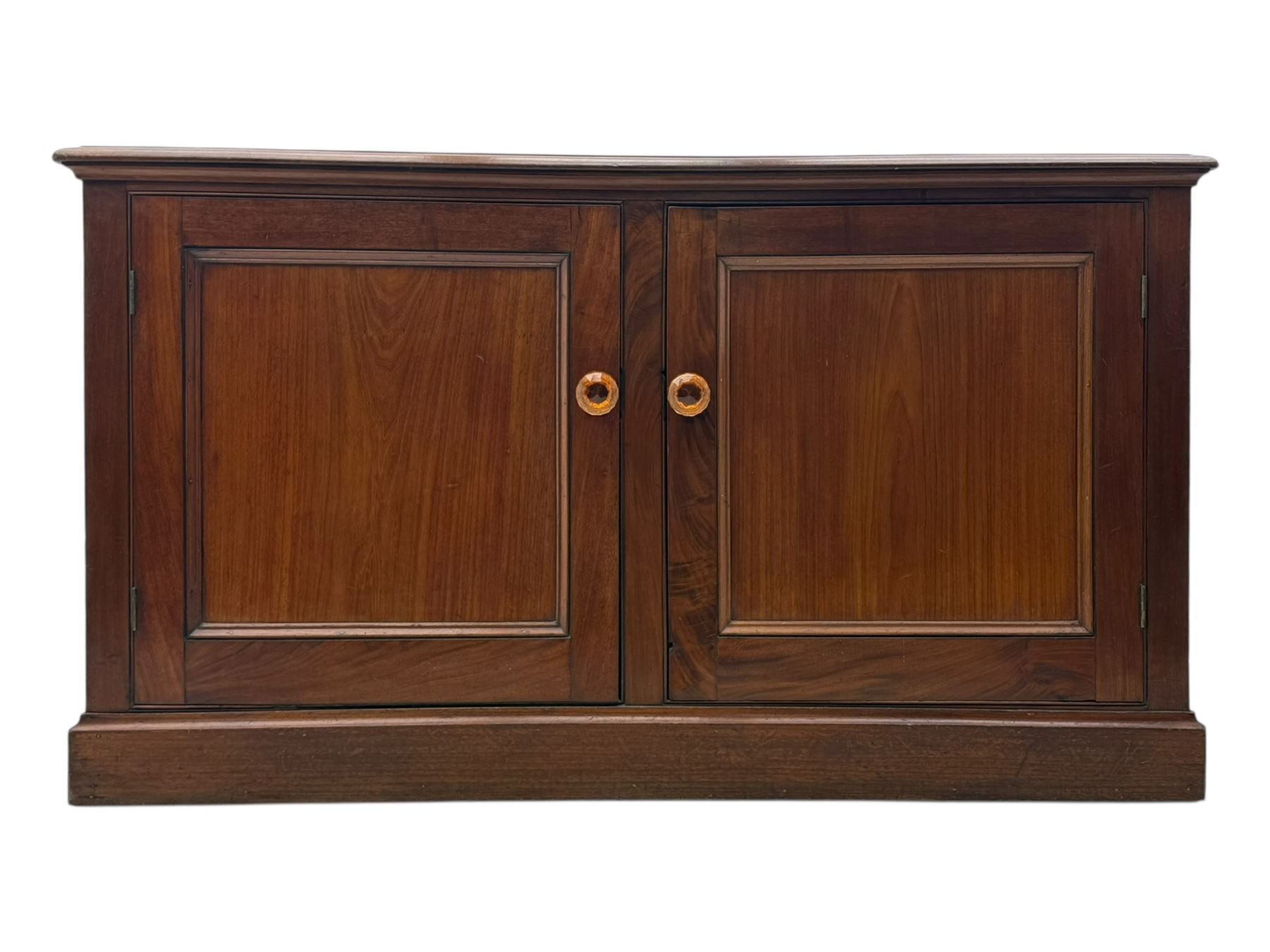 Victorian mahogany cupboard, plain rectangular top above two fielded panel doors opening to shelved interior, raised on a moulded plinth base, with later replacement knob handles